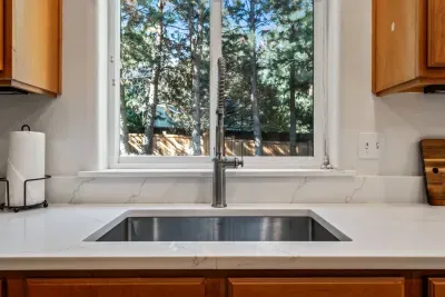 Fully-stocked kitchen with new quartz countertops and bar seating for 4