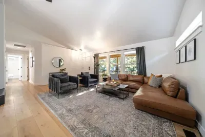 Modern, bright, large living room for all to gather around for a movie near the fireplace!