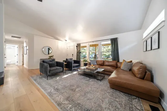 Modern, bright, large living room for all to gather around for a movie near the fireplace!