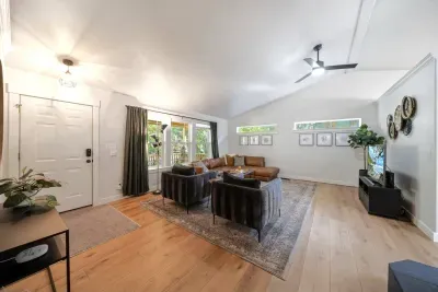 Modern, bright, large living room for all to gather around for a movie near the fireplace!