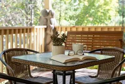 Front porch offers dining seating and porch swing to enjoy a quiet book. You'll find this street is super quiet with little traffic, but walkable to some incredible spots in town!