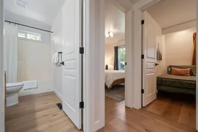 Main hallway that shows Bathroom 2 (full bathroom) and Bedroom 2 (Queen) and Bedroom 3 (2 twins)