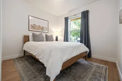 Beautifully appointed Queen bedroom with black-out drapes and closet