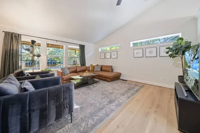 Modern, bright, large living room for all to gather around for a movie near the fireplace!
