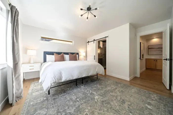Massive primary suite with king bed, dedicated office space, private door to back deck, and beautiful sliding barndoor to the primary ensuite bathroom. There are an additional 2 rollaway twin beds (best for small adult or child) stored in the closet.