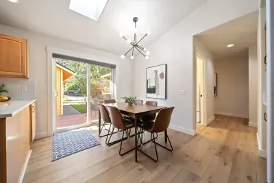 Hallway leads to laundry room and three bedrooms and two full bathrooms