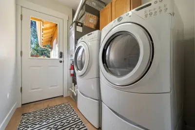 Laundry room provides a washer and dryer elevated on stools for easier access. Free for guest use. Detergent is provided.
