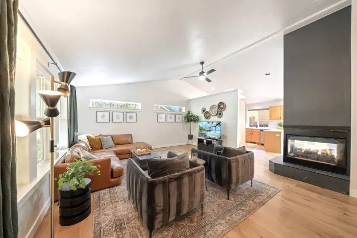 Modern, bright, large living room for all to gather around for a movie near the fireplace!