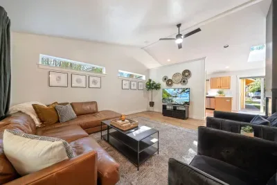 Modern, bright, large living room for all to gather around for a movie near the fireplace!