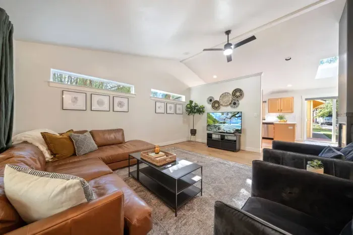 Modern, bright, large living room for all to gather around for a movie near the fireplace!