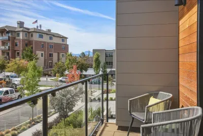 Private balcony with seating and open neighborhood views