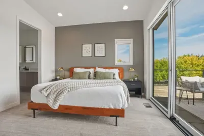 Bright modern bedroom with private patio access and serene outdoor views