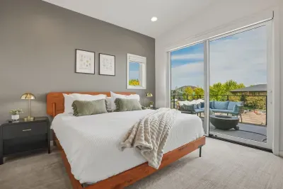 Bright modern bedroom with private balcony and stylish outdoor lounge