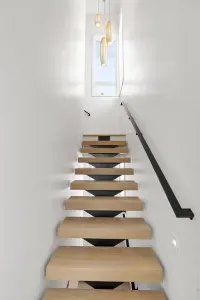 Floating staircases grace the second and third floors and provide a modern energy to the home.