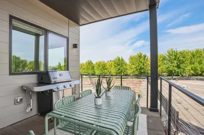 Covered patio with grill and stylish outdoor dining for six