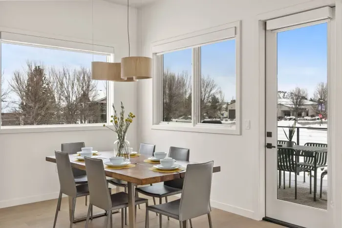 Access to one of four balconies from the dining area, outfitting with natural gas BBQ and outdoor dining table. This covered area is perfect for year-round BBQing!