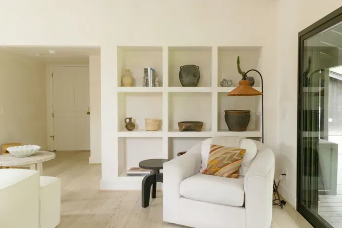 Bright modern lounge with curated built-ins and natural light