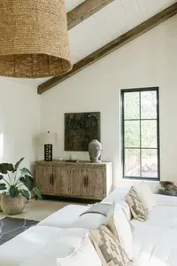 Bright designer living room with vaulted ceilings and rustic-modern charm