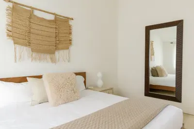 Bright minimalist bedroom with cozy neutrals and natural textures