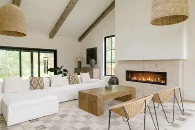 Airy designer living room with vaulted ceilings and a sleek fireplace