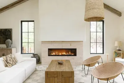 Bright vaulted living room with modern fireplace and designer seating