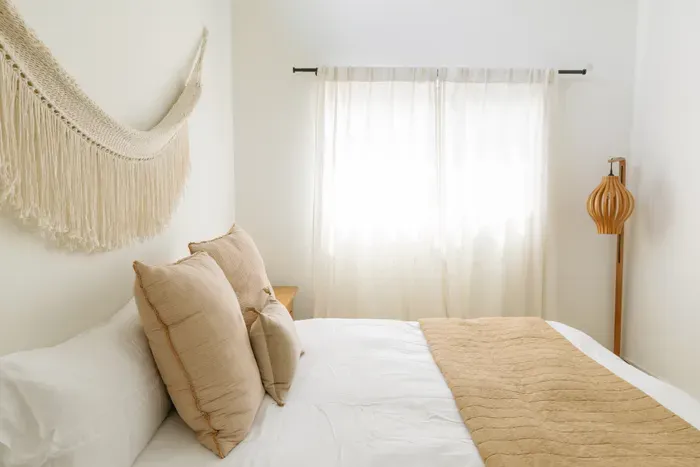 Bright boho bedroom with soft neutrals and serene natural light