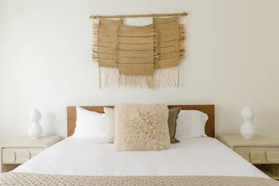 Calming boho bedroom with crisp linens and stylish woven accents