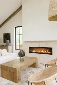 Bright modern lounge with vaulted ceilings and a sleek fireplace