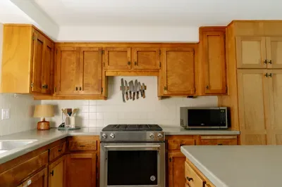 Warm, spacious kitchen with island, ample storage, and full-size range