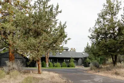 Private wooded retreat with paved drive and charming covered porch