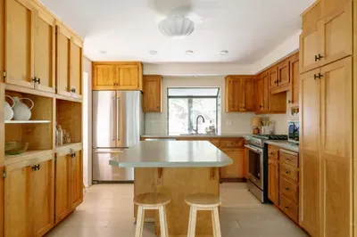 Bright kitchen with large island seating and stainless steel appliances