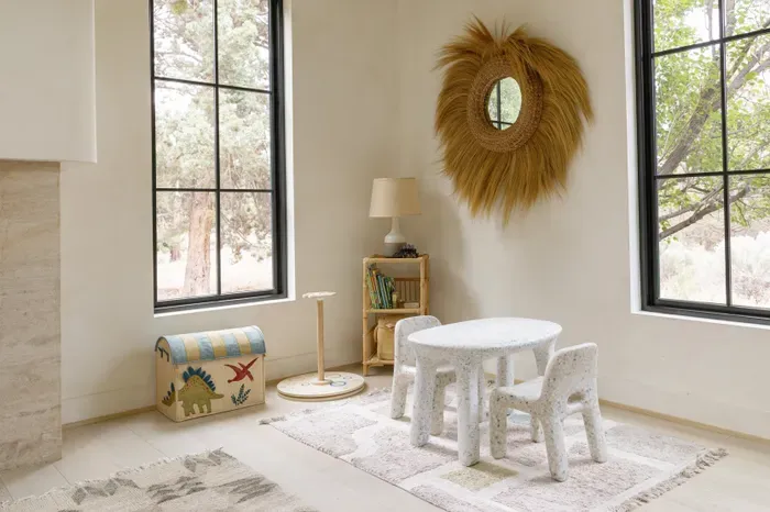 Bright kids’ nook with tree views, natural light, and charming decor