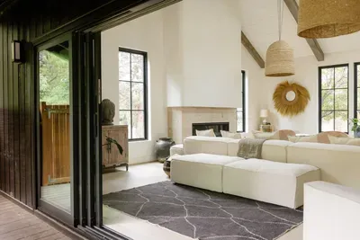 Bright designer living room with fireplace and seamless indoor-outdoor flow