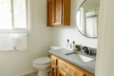 Bright modern bathroom with natural light, wood vanity, and sleek finishes