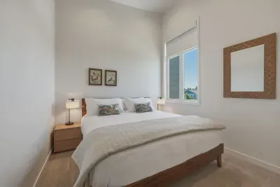 Bright, airy bedroom with high ceilings and a cozy, modern feel