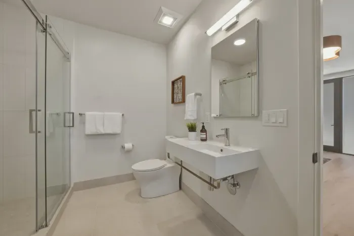 Bright modern bathroom with glass shower and sleek floating vanity