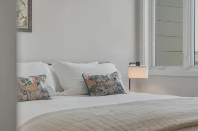 Bright, cozy bedroom with crisp linens and calming natural light