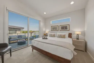 Bright king bedroom with private balcony and stylish outdoor seating