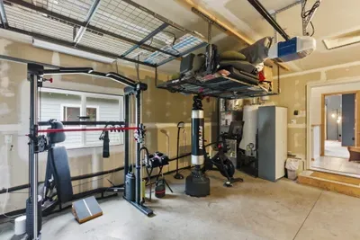 Private garage gym with boxing bag, bike, and organized storage