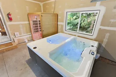 Private hot tub and sauna with serene forest views