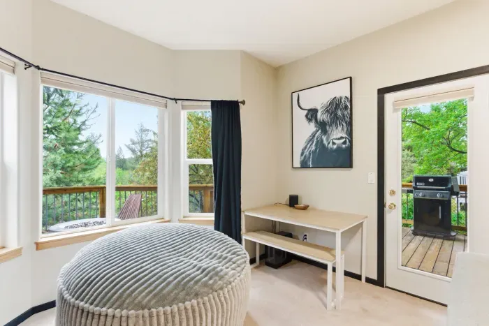 Bright room with treetop views and private deck access with grill