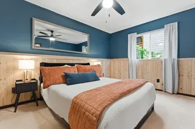 Cozy, stylish bedroom with warm accents, wood details, and natural light