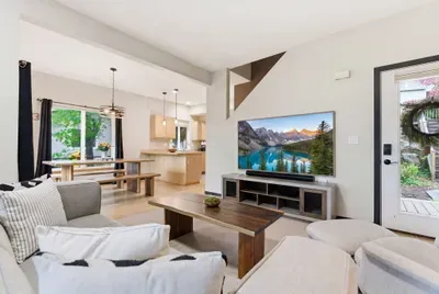 Bright open living space with large TV, dining area, and natural light