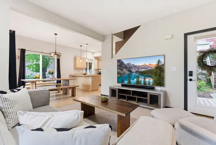 Bright open living space with large TV, dining area, and natural light