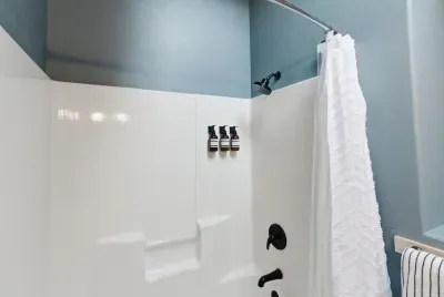 Bright modern shower with sleek fixtures and fresh guest-ready touches