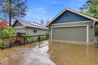 Peaceful wooded home with 2-car garage and spacious driveway