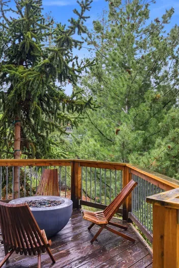 Forest-view deck with fire pit and stylish lounge seating