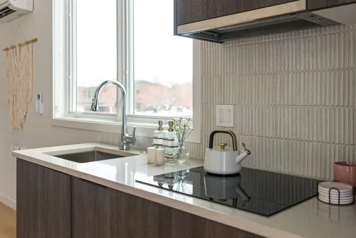 A nearly full kitchen! Sink, built in dishwasher, induction cooktop, micro/oven combo, mini fridge (no freezer!), plenty of storage and all the kitchenwares you need - coffee maker, plates, bowls, cups, utensils etc.