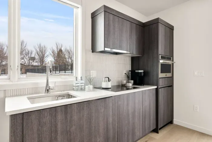 A nearly full kitchen! Sink, built in dishwasher, induction cooktop, micro/oven combo, mini fridge (no freezer!), plenty of storage and all the kitchenwares you need - coffee maker, plates, bowls, cups, utensils etc.
