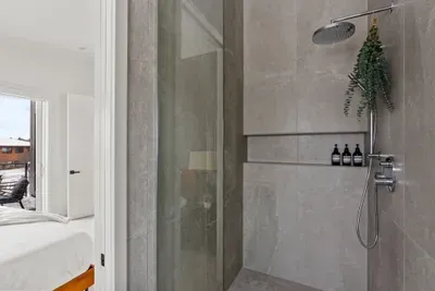 Spa-like walk-in rain shower with sleek modern finishes